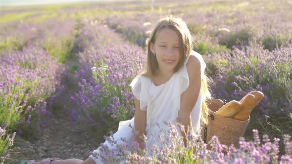 Girl in Lavender Flowers Field in White Dress