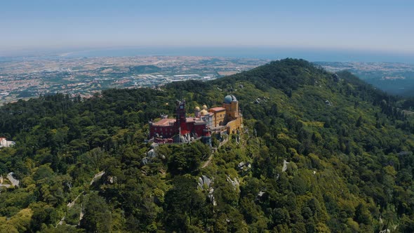 Drone shot of Pena Palace and National Park in Sintra, The Colorful Ancient Castle, Portugal 4K