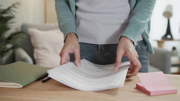 Close up shot of businesswoman work from home hand holding financial report paperwork document