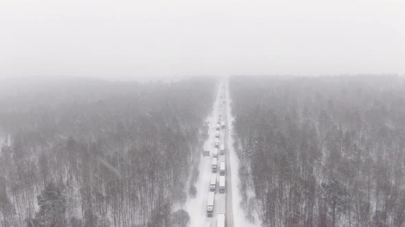 Trucks are Stuck in Traffic on a Snowcovered Highway