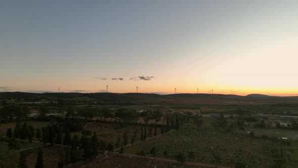 Landscape View During Dusk with Wind Turbines Seen in Distance