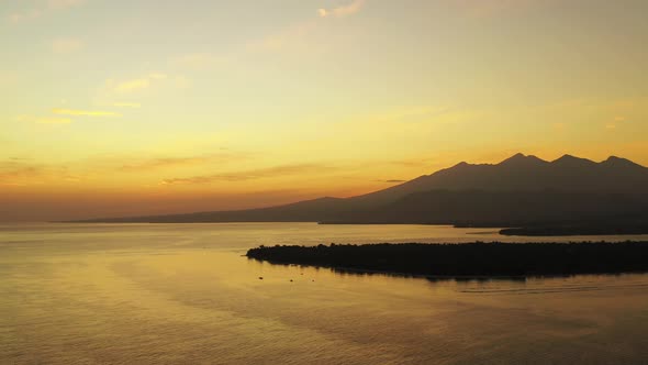 Romantic sunset over the Gilli Islands, Bali, Indonesia. Cinematic aerial seascape, golden colored s alt
