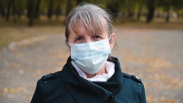 Portrait of a Senior Woman in a Medical Protection Mask