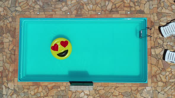 Smile emoji icon floating at swimming pool at countryside alt