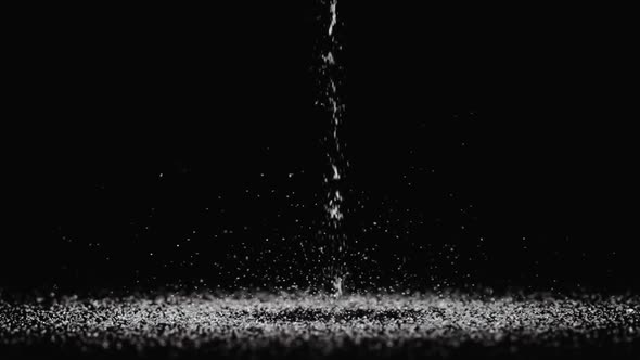 Particles of White Dry Sand Pour in Stream Hit the Surface and Scatter in Different Directions on an alt