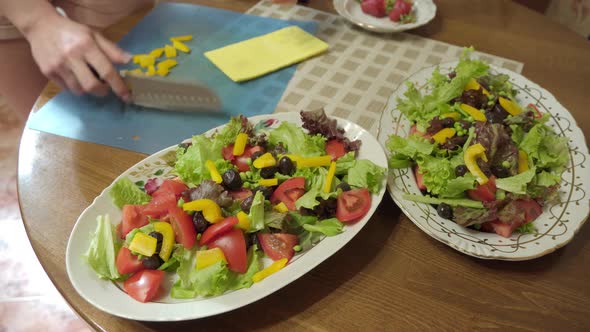 Female Hands Making Healthy Vegetable Salad at Home Kitchen alt