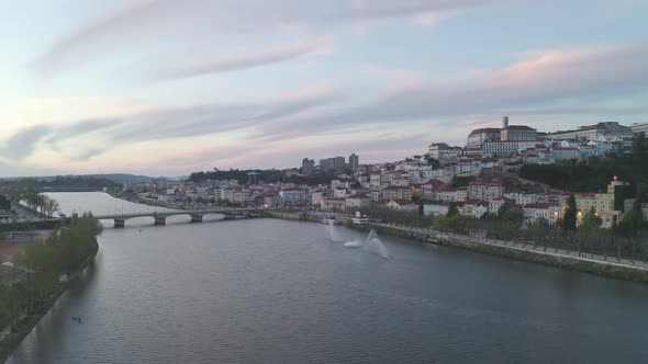 Aerial drone view of Coimbra city and Mondego river at sunset alt