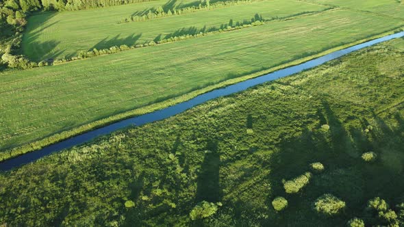 The River Flows In The Green Valley. In The Light Of The Bright Setting Sun. alt