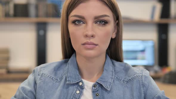 Young Woman in Office Looking at Camera alt