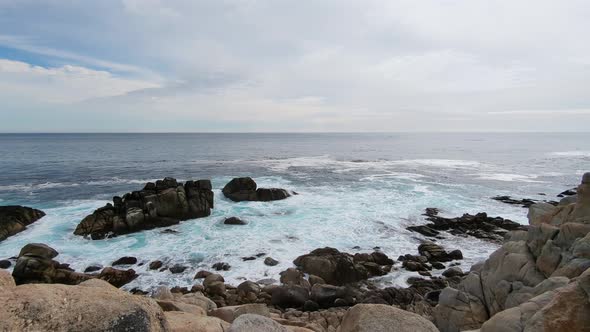 Blue ocean waves hitting rocks at Monterey Beach, 17 mile Drive Spanish bay in Monetery, California. alt