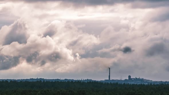 Gray Cumulus Clouds Moves Over the Horizon and an Industrial Plant Timelapse alt