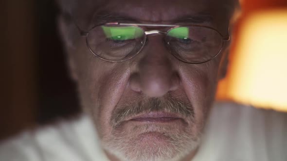 Portrait of an Elderly Whitehaired Man with Glasses Looking at a Laptop Screen Focused Man Reading alt