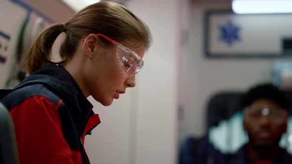 Serious Ambulance Paramedic Driving in Emergency Vehicle on 911 Call alt