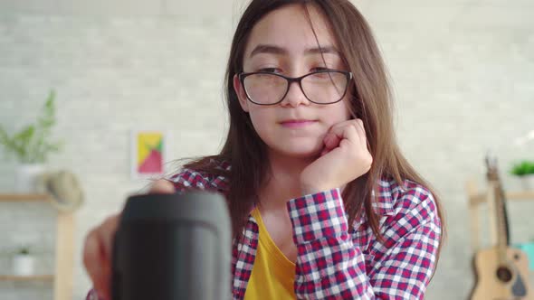 Portrait Beautiful Asian Girl in Glasses with Long Hair in the Living Room Modern Reading a Book and alt