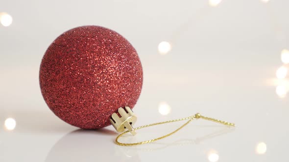Decorative red bauble with sequins close-up 4K 2160p 30fps UltraHD footage - Shiny Christmas ornamen alt