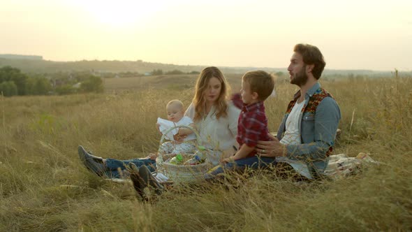 Parents Playing with Kids During Picnic in Field