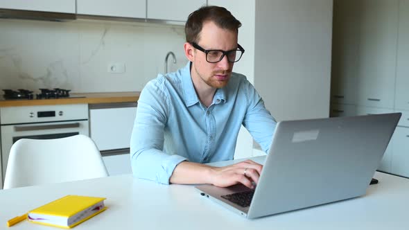 Smart Young Businessman Using Laptop Computer for Remote Work From Home alt