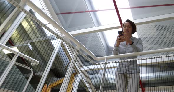 Businesswoman using mobile phone in modern office 4k