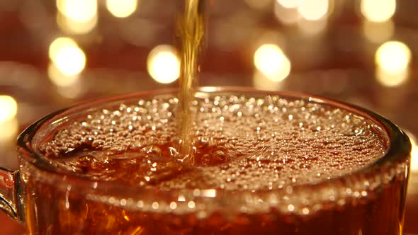 Hot Black Tea Being Poured Into Glass Transparent Cup, Closeups alt