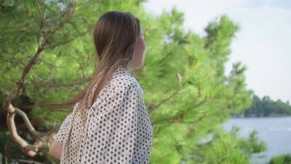 Girl Walking and Making a Pause to Enjoy Sea View alt