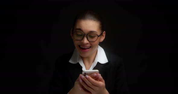 Cheerful Business Woman Laughs After Reading a Message in a Mobile Phone alt