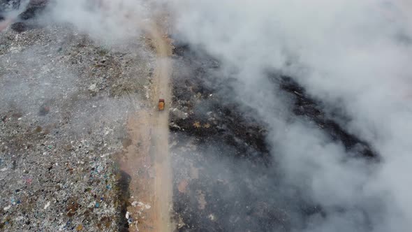 Drove view truck move red clay soil to help save the fire from open burn alt