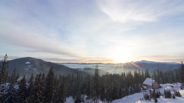 Aerial View of Sunrise in Winter Forest Mountains with Lot of Snow and Snowy Trees in Cold Morning