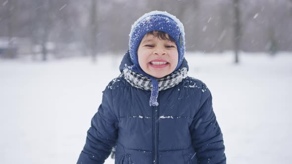 Portrait of a Boy in Winter Showing Teeth alt