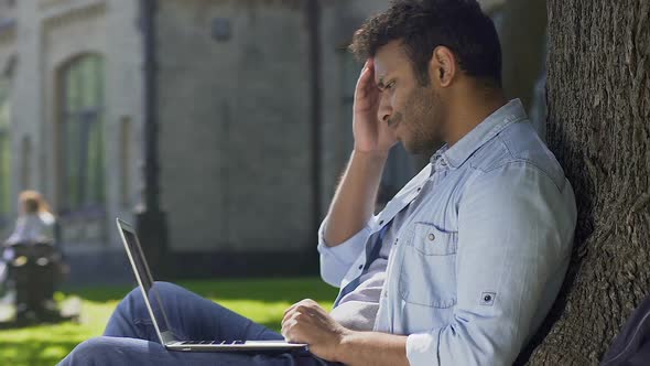 Young Man Receiving Letter on Laptop, Failed Semester and Not Admitted to Exams alt