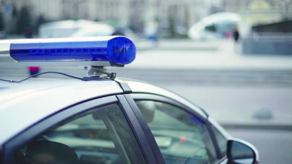 Flashing Flasher on the Roof of a Police Car. Blinker. Close-up. alt