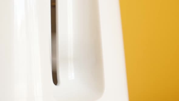 Handle pops up on two-slot automatic electric toaster slow motion footage alt