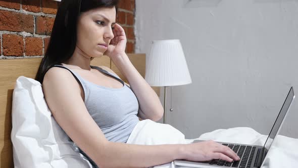 Headache, Woman Working on Laptop in Bed, Blood Pressure alt
