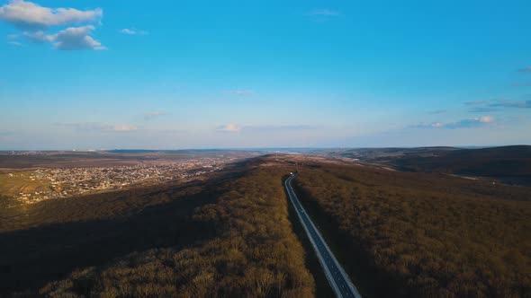 Aerial View of Cars Traveling Middle of the Forest on the Road alt