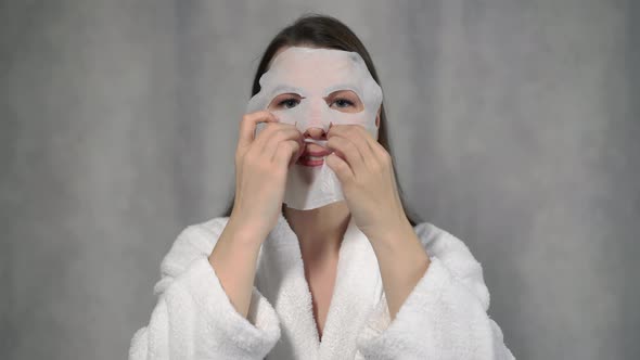 Young Woman Takes Care of Skin of Face