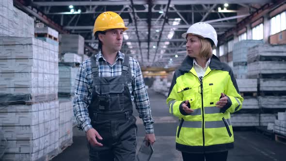 Follow Footage of Employees Male and Famale Warehouse Worker Engineer in Hard Hat Working alt