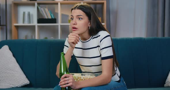Woman Sitting on the Couch in front of TV During Watching Sports Competition alt