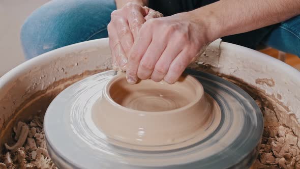 Man Potter Sculpting a Pot Out of Clay - Forming Sides alt