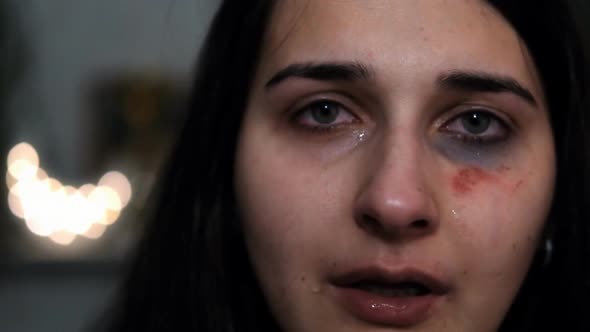 A Young Woman with an Injury on Her Face Is Crying. Consequences of Violence