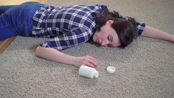 Young Woman Lies Unconscious at Home on the Floor After a Seizure Before Reaching for a Smartphone alt