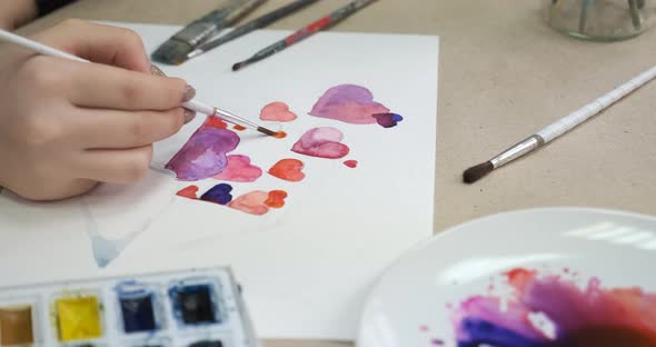 Process of Painting Card with Hearts for Valentine's Day Closeup