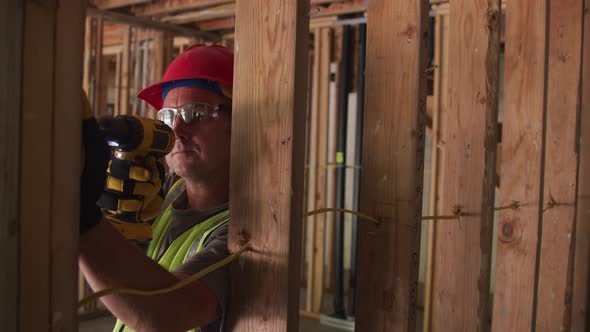 Construction worker using screw gun