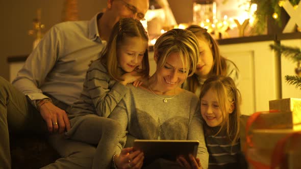 Happy Family Looking Into Tablet