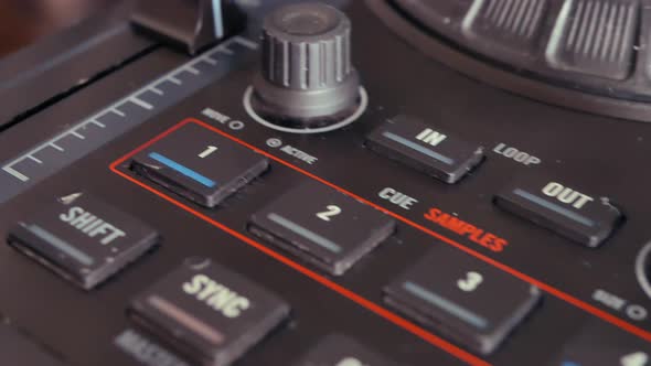 DJ mixing controller and audio gear at edm festival. alt