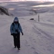 Girl walking on a snow in high winds, Kvaloya, Arctic, Norway - VideoHive Item for Sale