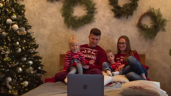 Happy Family Watching Movie Together at Christmas