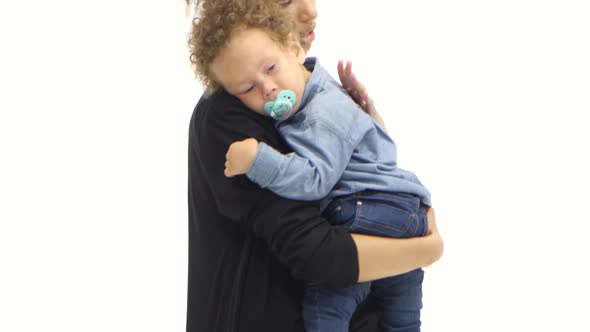 African American Mother Is Shaking a Small Child in Her Arms. White Background alt