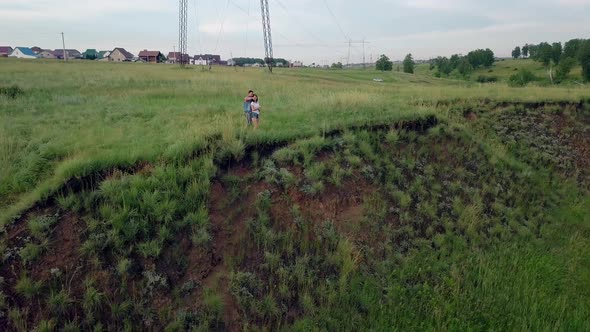 Camera Removes From Couple Admiring Country with Blue Lake alt