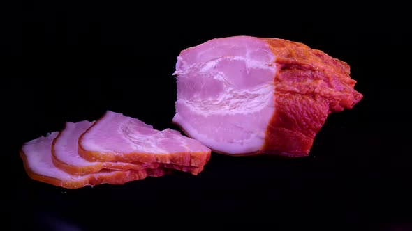 A piece of boiled pork on a dark background and cut into pieces alt