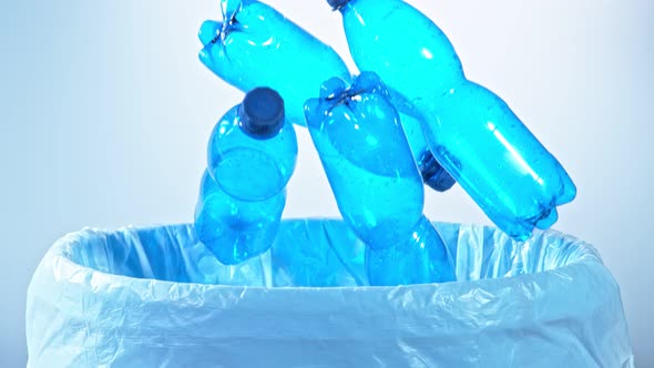Super Slow Motion Shot of Empty Plastic Bottles Falling Into Trash Can at 1000Fps alt