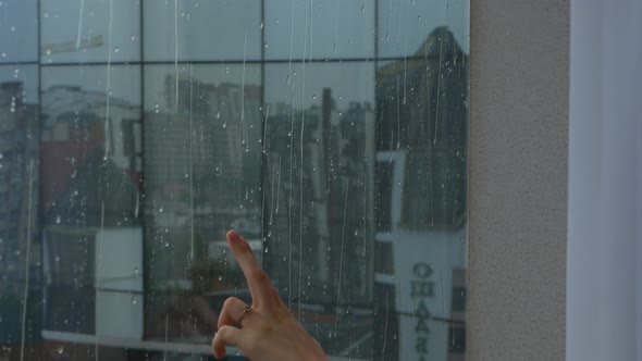 Shooting As a Girl Runs Her Hands Through the Window During the Rain